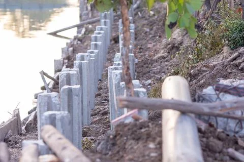 Selective focus to cement or concrete pillar, pole on along the canal site. Stock Photos