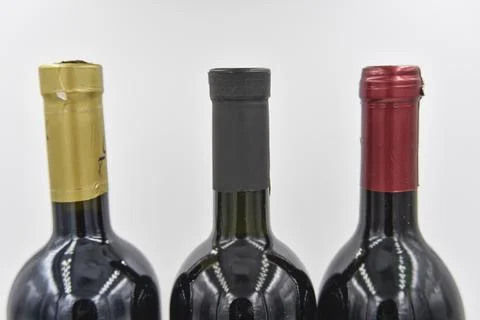 Selective focus at the center of three wine bottle necks Stock Photos