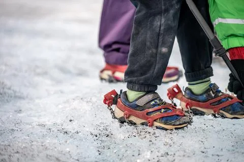 Selective focus on chain spikes on a pair of shoes for added traction on ice. Stock Photos