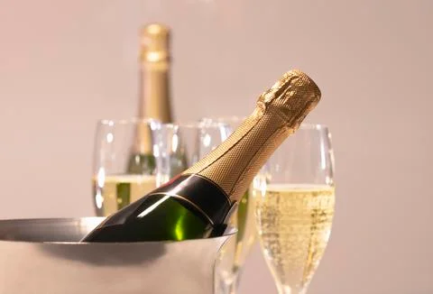 Selective focus of a champagne bottle inside a champagne bucket with out of f Stock Photos