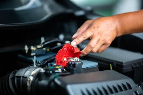 Selective focus to check and maintenance the battery in car with yourself. Stock Photos