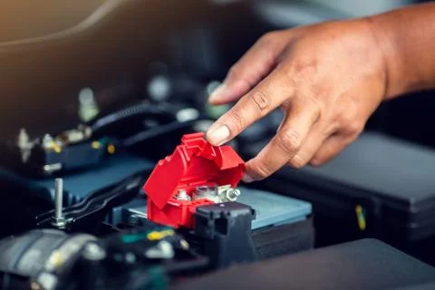 Selective focus to check and maintenance the battery in car with yourself. Stock Photos
