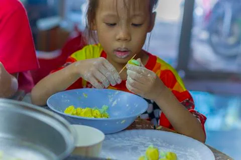 Selective focus of children preparing dough for cooking Thai dessert. Stock Photos