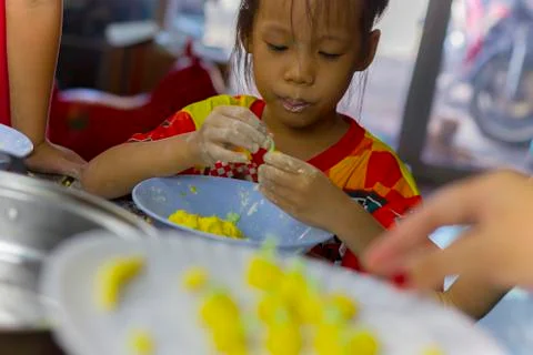 Selective focus of children preparing dough for cooking Thai dessert. Stock Photos