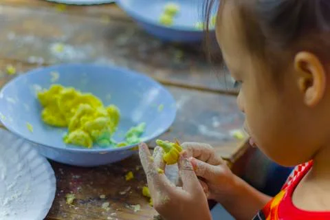 Selective focus of children preparing dough for cooking Thai dessert. Stock Photos