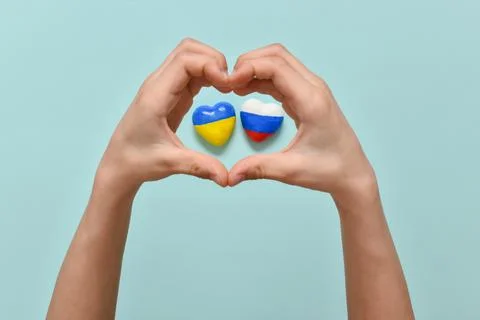 Selective focus. Children's hands hold palms in the shape of hearts in the ce 库存照片