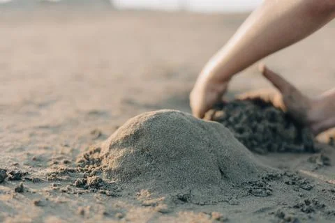 Selective focus childrens hands playing with sand on summer beach. Vacation Stock Photos