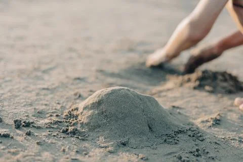 Selective focus childrens hands playing with sand on summer beach. Vacation Stock Photos