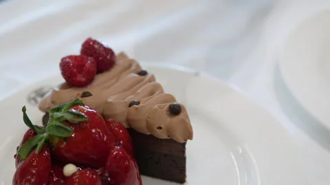 Selective focus to chocolate cake while using silver fork to cut cake to ea.. Stock Footage 283629194