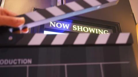 Selective focus of Clapper board or movie slate with hand in front of now sho Stock Photos