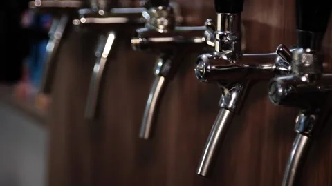 Selective focus, close-up of beer taps in a bar, smooth camera movement Stock Footage 224827142