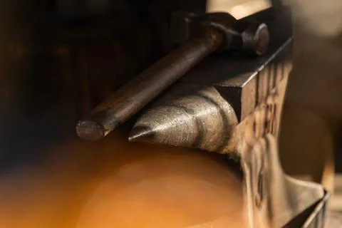 Selective focus close-up of a blacksmith's hammer on a metal anvil, play Stock Photos