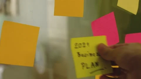 Selective focus, close up indoor shot at hand of businessman put colorful pos Video stock 146363946