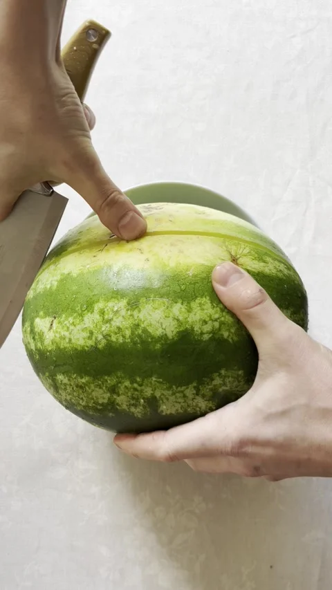 Selective focus close-up of male hand cutting ripe watermelon Stock Footage 334330576