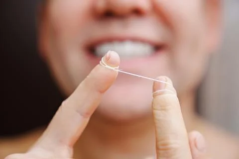 Selective focus. close-up. a man brush your teeth with dental floss Stock Photos