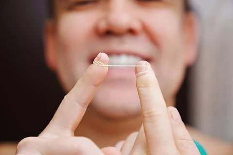 Selective focus. close-up. a man brush your teeth with dental floss Stock Photos