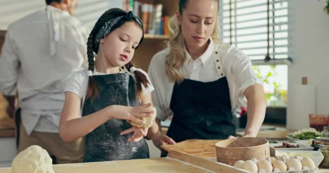 Selective focus close up shot pretty preschooler daughter kneading dough on 库存影片 218634442