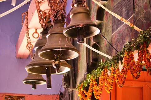Selective focus close up of three temple bells hanging at the entrance of a h Stock Photos