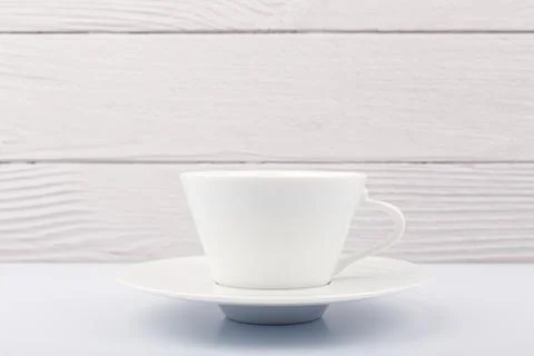Selective focus, close up of white ceramic coffee or tea cup against white Stock Photos