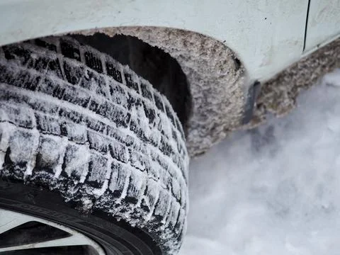 Selective focus. Close-up of a winter car tire tread with snow and ice. 스톡 사진