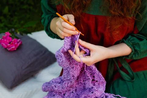 Selective focus. Close-up of women's hands knitting a shawl. Stock Photos
