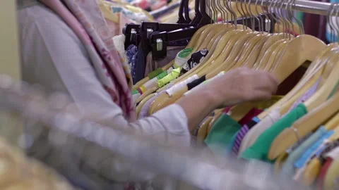 Selective focus of the clothes on display with the salesperson arranging th.. Stock Footage 326307666