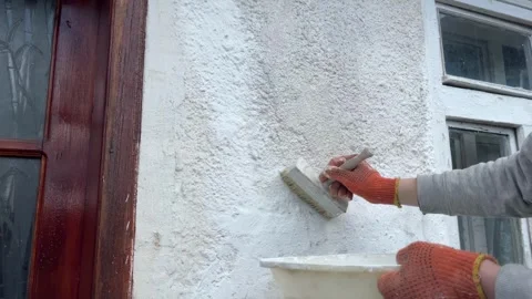 Selective focus coating exterior wall with lime solution Stock Footage 334329723