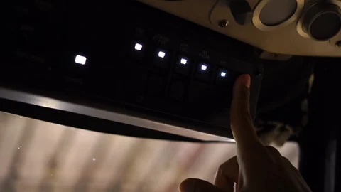 Selective focus of cockpit overhead panel switch with pilot hand pressing Stock Footage 108541408