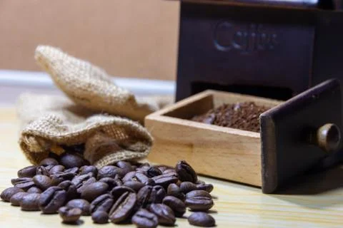 Selective focus coffee beans and grinded beans in vintage wooden coffee grind Stock Photos