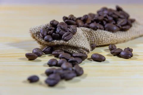 Selective focus coffee beans and grinded beans in vintage wooden coffee grind Stock Photos