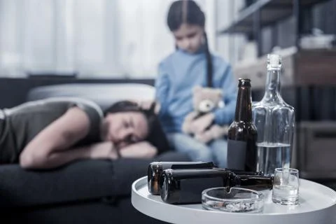 Selective focus of coffee table with empty bottles Stock Photos