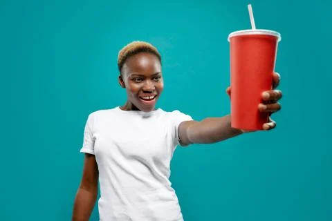 Selective focus of cold drink in hand of african female Stock Photos