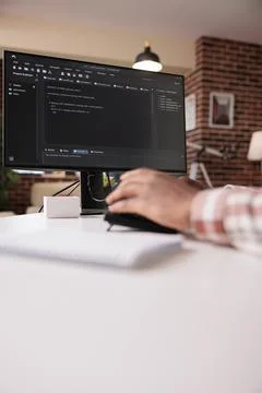 Selective focus on computer screen of african american programmer working remote Stock Photos