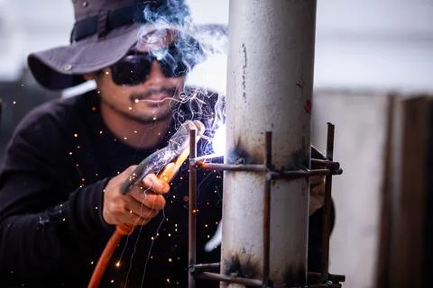 Selective focus to Construction Worker Welding Steel Pole with Sparks Outdoor Stock Photos
