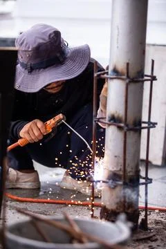 Selective focus to Construction Worker Welding Steel Pole with Sparks Outdoor Stock Photos