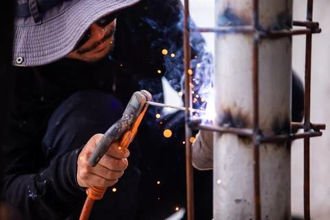 Selective focus to Construction Worker Welding Steel Pole with Sparks Outdoor Stock Photos