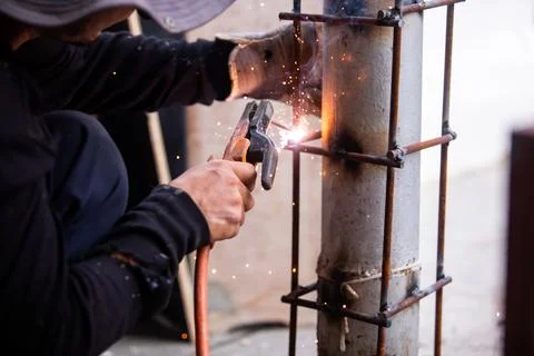 Selective focus to Construction Worker Welding Steel Pole with Sparks Outdoor Stock Photos