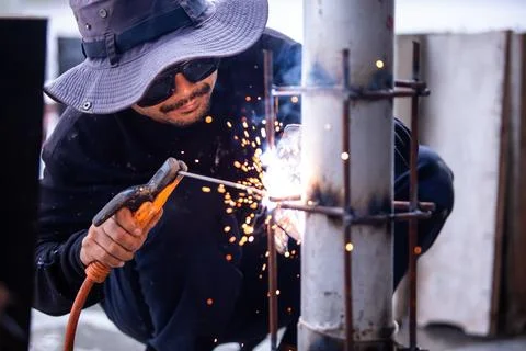 Selective focus to Construction Worker Welding Steel Pole with Sparks Outdoor Stock Photos