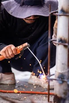 Selective focus to Construction Worker Welding Steel Pole with Sparks Outdoor Stock Photos
