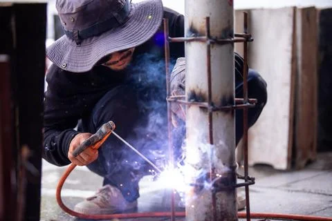 Selective focus to Construction Worker Welding Steel Pole with Sparks Outdoor Stock Photos