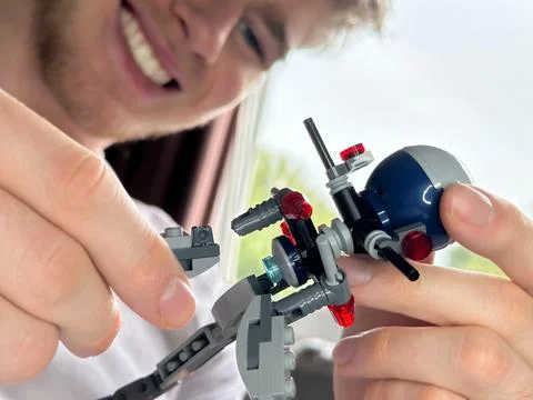 Selective focus on constructor toy happy man is putting together Stock Photos