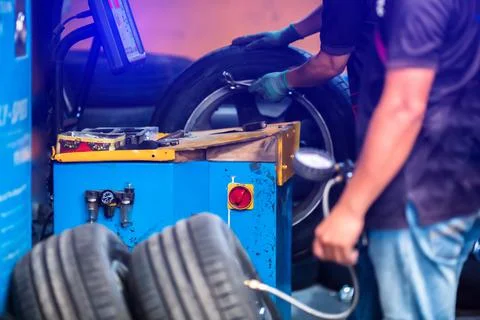 Selective focus to control panel of wheel balancer machine with blurry auto m Stock Photos