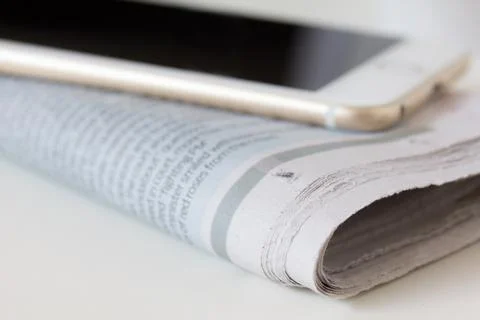Selective focus of corner newspaper, smart phone on newspaper Stock Photos