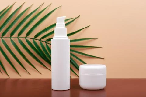 Selective focus, cosmetic set with hands cream and cuticle oil against beige Stock Photos