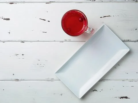 Selective focus on cranberries floating in a fresh red drink in a glass cup Stock Photos