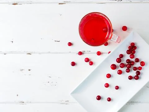 Selective focus on cranberries in a fresh drink in a glass cup Stock Photos