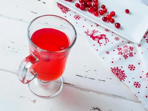 Selective focus on cranberries in a fresh drink in a glass cup. Stock Photos