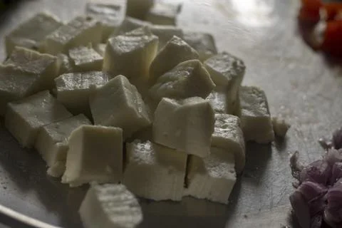 Selective focus of cube pieces of Indian cheese. Stock Photos