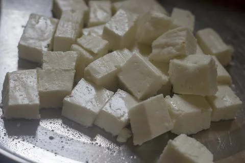 Selective focus of cube pieces of Indian cheese. Stock Photos