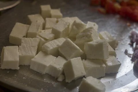 Selective focus of cube pieces of Indian cheese. Stock Photos
